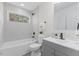 Modern bathroom with combined shower and tub and gray vanity at 409 Avery St, Garner, NC 27529