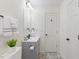 Clean bathroom with a modern gray vanity, new fixture, and gray accent rug at 409 Avery St, Garner, NC 27529