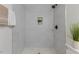 Updated bathroom featuring tiled walk-in shower, modern fixtures, and fresh paint at 409 Avery St, Garner, NC 27529