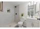 Bathroom featuring tiled walk-in shower, gray vanity, and modern fixtures at 409 Avery St, Garner, NC 27529