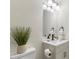 Updated half bath featuring new vanity, fresh paint, and modern fixtures at 409 Avery St, Garner, NC 27529