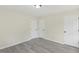 An empty room with clean, freshly painted walls and luxury hard wood floors at 409 Avery St, Garner, NC 27529