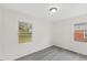 Bright bedroom with hard wood floors and two windows providing natural light at 409 Avery St, Garner, NC 27529