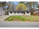 Charming single-story home with a well-maintained lawn and a classic white brick facade at 409 Avery St, Garner, NC 27529
