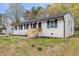 Charming single-story home with a well-maintained lawn and a classic white brick facade at 409 Avery St, Garner, NC 27529