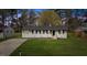 Charming single-story home with a well-maintained lawn and a classic white brick facade at 409 Avery St, Garner, NC 27529