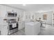 Bright kitchen with stainless steel appliances, white cabinetry, and an island at 409 Avery St, Garner, NC 27529