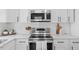 Updated kitchen features stainless steel appliances, white cabinetry, and modern finishes, perfect for cooking at 409 Avery St, Garner, NC 27529