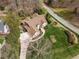 An aerial view of a home reveals a landscaped backyard, brown roof, and a winding driveway at 5300 Mandrake Ct, Raleigh, NC 27613