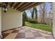 A covered patio features a brown and tan checkered floor pattern and views of the landscaped backyard at 5300 Mandrake Ct, Raleigh, NC 27613