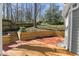 Charming backyard patio area with brick accents and wooden stairs at 6008 Chittim Ct, Raleigh, NC 27616
