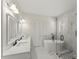Modern bathroom featuring double vanity, soaking tub and glass shower at 6008 Chittim Ct, Raleigh, NC 27616