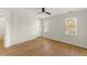 Bedroom featuring hardwood floors, ceiling fan and large windows at 6008 Chittim Ct, Raleigh, NC 27616