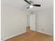 Bedroom with hardwood floors, neutral wall color, ceiling fan, and two doorways at 6008 Chittim Ct, Raleigh, NC 27616