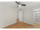 Bedroom with hardwood floors, neutral wall color, closet, ceiling fan, and two doorways at 6008 Chittim Ct, Raleigh, NC 27616