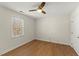 Clean and bright bedroom with hardwood floors, ceiling fan, window with backyard view at 6008 Chittim Ct, Raleigh, NC 27616
