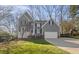 Beautiful home with a two-car garage, nestled amongst trees, on a sunny day at 6008 Chittim Ct, Raleigh, NC 27616