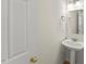 Cozy half bathroom with pedestal sink, mirror and a neutral color palette at 6008 Chittim Ct, Raleigh, NC 27616
