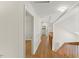 Hallway with stairs, hardwood floors, neutral wall color, skylight and a doorway at 6008 Chittim Ct, Raleigh, NC 27616