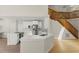 Modern kitchen featuring white cabinetry, stainless steel appliances, quartz countertops and wooden stair case at 6008 Chittim Ct, Raleigh, NC 27616