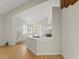 Sunlit kitchen with a breakfast bar, light wood floors, and multiple windows with natural light at 6008 Chittim Ct, Raleigh, NC 27616