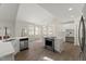 Open kitchen with island, modern appliances, and breakfast area, with easy access to the patio at 6008 Chittim Ct, Raleigh, NC 27616