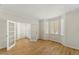 Sun-filled living room showcasing hardwood floors, large windows, and elegant trim at 6008 Chittim Ct, Raleigh, NC 27616