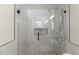 Modern shower with glass doors, rainfall showerhead, and decorative tile details at 6008 Chittim Ct, Raleigh, NC 27616