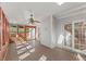 Bright sunroom with hardwood floors, ceiling fan and sliding doors to outdoor space at 6008 Chittim Ct, Raleigh, NC 27616
