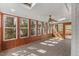 Bright sunroom features ceiling fan and an abundance of windows with backyard views at 6008 Chittim Ct, Raleigh, NC 27616