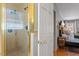 This bathroom features a glass shower with gold trim and a view into the bedroom at 609 Brookview Dr, Chapel Hill, NC 27514