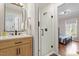 Stylish bathroom with a glass shower, a modern vanity, and a doorway leading to the primary bedroom at 609 Brookview Dr, Chapel Hill, NC 27514