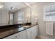 Elegant bathroom featuring a dark countertop, gold accents, white cabinets and great lighting at 609 Brookview Dr, Chapel Hill, NC 27514