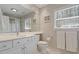 Bright bathroom featuring a large mirror, white cabinets, and plenty of natural light at 609 Brookview Dr, Chapel Hill, NC 27514