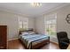 Light-filled bedroom with hardwood floors and neutral decor at 609 Brookview Dr, Chapel Hill, NC 27514