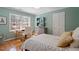 Bright bedroom with a desk area near the window, hardwood floors, and neutral wall paint at 609 Brookview Dr, Chapel Hill, NC 27514