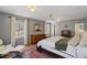 Spacious primary bedroom featuring hard wood floors, a comfortable chair, and an abundance of natural light at 609 Brookview Dr, Chapel Hill, NC 27514