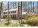 Charming two-story home featuring a brick facade, black shutters, and a well-manicured lawn with mature trees at 609 Brookview Dr, Chapel Hill, NC 27514