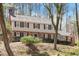 Classic two-story home with brick accents, neutral siding, and manicured landscaping on a sunny, tree-lined lot at 609 Brookview Dr, Chapel Hill, NC 27514