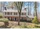 Traditional two-story home with brick and siding, complemented by black shutters and a meticulously landscaped front yard at 609 Brookview Dr, Chapel Hill, NC 27514