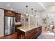 Bright kitchen with stainless appliances, large island, and stylish tile floors at 609 Brookview Dr, Chapel Hill, NC 27514