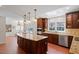 Gourmet kitchen featuring an island with seating, stainless steel appliances, and tile floors at 609 Brookview Dr, Chapel Hill, NC 27514