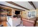 Comfortable living room featuring a brick fireplace, built-in shelving, and exposed wood beams on the ceiling at 609 Brookview Dr, Chapel Hill, NC 27514
