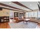 Inviting living room featuring wood beams, built-in bookshelves, and large windows at 609 Brookview Dr, Chapel Hill, NC 27514