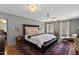 Spacious main bedroom with hardwood floors, two windows, and a ceiling fan at 609 Brookview Dr, Chapel Hill, NC 27514