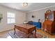 Traditional office with wood desk, blue cabinet, and antique wood hutch cabinet with lots of natural light at 609 Brookview Dr, Chapel Hill, NC 27514
