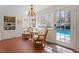 Cozy sun room with access to pool, tile flooring, and chandelier at 609 Brookview Dr, Chapel Hill, NC 27514