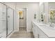 Bright bathroom with double vanity, framed mirrors, shower, and modern fixtures at 705 Deschutes Dr, Garner, NC 27529