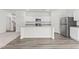 Open concept kitchen with an island, stainless appliances, and modern finishes at 73 Club Rd, Louisburg, NC 27549