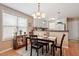 Charming dining area featuring a wooden table set, chandelier, and a window offering ample natural light at 75 E Moss Creek Dr, Clayton, NC 27520